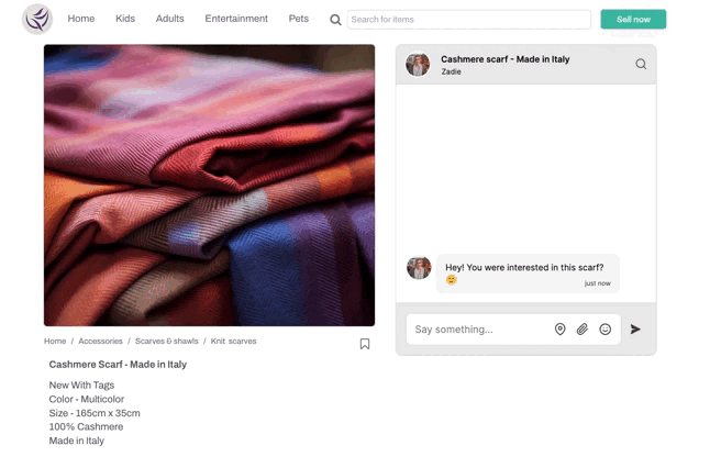 An overview of a Bubble clothing and textile marketplace app. At the top is a navigation menu, search bar, and a button ‘Sell now’. The left half the screen holds a large image of a red and purple cashmere scarf, folded, with product information underneath. To the right of the image is a TalkJS chat box window with the conversation subject ‘Cashmere Scarf - Made in Italy’ and participants talking about details of the product offered. 